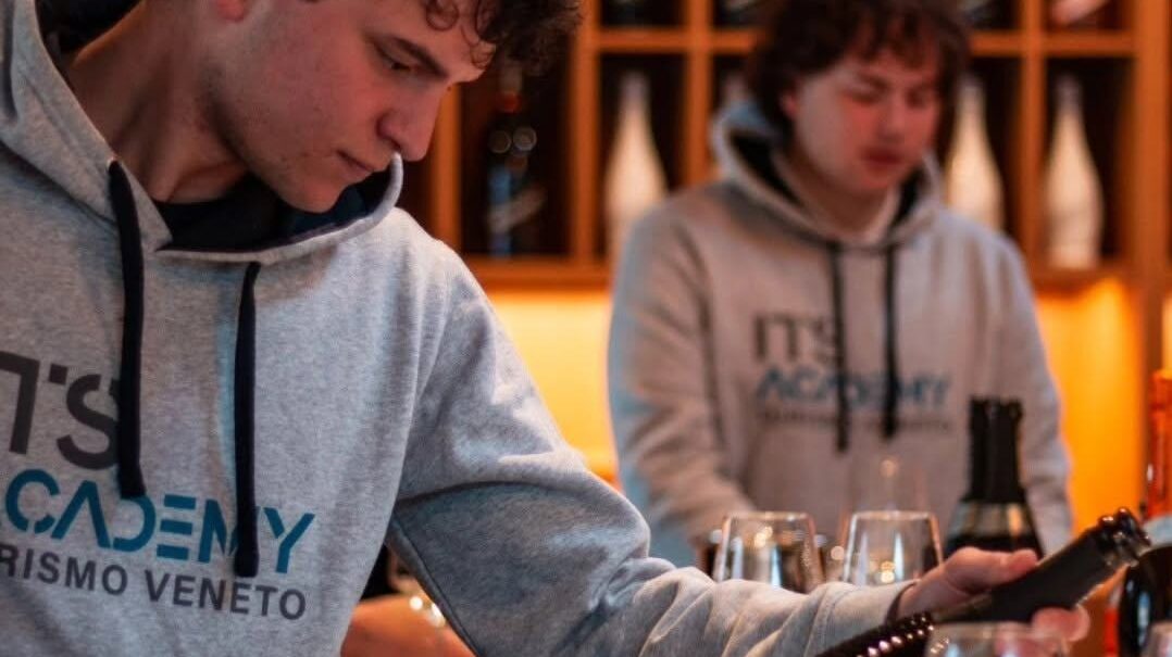 ragazzo che guarda una bottiglia di vino